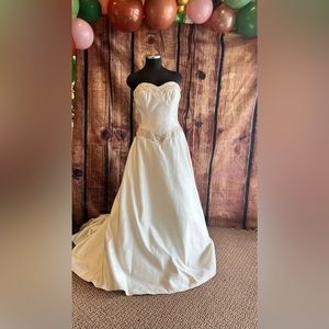 Ivory strapless wedding dress with tan beaded trim.